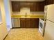 Well-lit kitchen with oak cabinets, stainless steel dishwasher, white appliances, and functional layout for efficient meal preparation at 13601 E Marina Dr # 508, Aurora, CO 80014