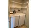 Convenient laundry area with washer, dryer, and shelving for storage at 13601 E Marina Dr # 508, Aurora, CO 80014