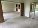 Spacious living room featuring neutral carpeting and an open floor plan leading to the kitchen at 13601 E Marina Dr # 508, Aurora, CO 80014