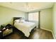 Inviting bedroom with ceiling fan, bright window, and dark wood-look flooring at 8625 Clay St # 228, Westminster, CO 80031