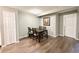 A formal dining room featuring wood floors, a modern light fixture, and seating for six at 8625 Clay St # 228, Westminster, CO 80031