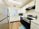 Well-lit kitchen featuring white cabinets, stainless steel appliances, and modern countertops at 8625 Clay St # 228, Westminster, CO 80031