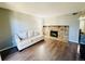 Bright living room featuring hardwood floors, fireplace with stonework, and a white sofa at 8625 Clay St # 228, Westminster, CO 80031