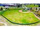 Aerial view of the community baseball field with trees and buildings in the distance at 2280 S Oswego Way # 104, Aurora, CO 80014