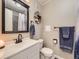 Well-lit bathroom with a modern sink, classic mirror, and decorative fixtures at 2280 S Oswego Way # 104, Aurora, CO 80014