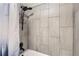 Updated bathroom featuring tiled walls and a modern, multi-setting shower head with a chrome storage rack at 2280 S Oswego Way # 104, Aurora, CO 80014