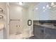 Sleek bathroom with walk-in shower featuring herringbone tile, modern fixtures, and marble floors at 2280 S Oswego Way # 104, Aurora, CO 80014