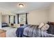 Carpeted bedroom with natural light and a sliding-door mirrored closet at 2280 S Oswego Way # 104, Aurora, CO 80014