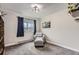 Bedroom with a comfortable chair, ottoman, and natural light at 2280 S Oswego Way # 104, Aurora, CO 80014