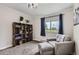 Cozy bedroom with a shelving unit, chair, and window at 2280 S Oswego Way # 104, Aurora, CO 80014