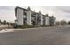 Front view of a multi-unit residential building with parking at 2280 S Oswego Way # 104, Aurora, CO 80014