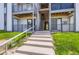 The back of the apartment building features a set of concrete stairs that leads to the second story at 2280 S Oswego Way # 104, Aurora, CO 80014