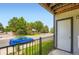 A condo featuring a cozy front porch with view of a blue car and a street lined with trees at 2280 S Oswego Way # 104, Aurora, CO 80014