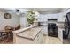 Well-lit kitchen featuring white cabinets and modern appliances, perfect for cooking at 2280 S Oswego Way # 104, Aurora, CO 80014