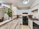 Modern kitchen with white cabinets and granite counters at 2280 S Oswego Way # 104, Aurora, CO 80014