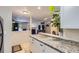 Open-concept kitchen showcasing granite countertops overlooking a living space with a fireplace at 2280 S Oswego Way # 104, Aurora, CO 80014