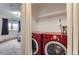 Convenient laundry area with red washer and dryer units at 2280 S Oswego Way # 104, Aurora, CO 80014