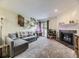 Inviting living room boasts a modern fireplace, and light-filled ambiance with views of the outdoors at 2280 S Oswego Way # 104, Aurora, CO 80014