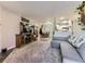Cozy living room featuring plush carpet, a fireplace, and seamless integration into the kitchen and dining area at 2280 S Oswego Way # 104, Aurora, CO 80014