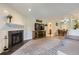 Bright living space with a fireplace, TV, and open floor plan to the dining area at 2280 S Oswego Way # 104, Aurora, CO 80014