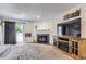 Comfortable living room with a fireplace, large TV, and access to outdoor space at 2280 S Oswego Way # 104, Aurora, CO 80014
