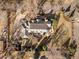 An overhead view of a landscaped property with a luxury home, stone patio, and beautiful, mature trees surrounding the home at 4160 S Humboldt St, Cherry Hills Village, CO 80113