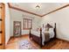 Cozy bedroom with a large mirror, wood floors, and wood trim at 4160 S Humboldt St, Cherry Hills Village, CO 80113