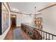 Hallway featuring wood floors, wood trim, and a decorative chandelier at 4160 S Humboldt St, Cherry Hills Village, CO 80113