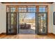 Inviting living room with hardwood floors showcasing an outdoor dining space and expansive backyard through large, glass doors at 4160 S Humboldt St, Cherry Hills Village, CO 80113
