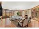 Bright living room with hardwood floors, fireplace, neutral sofa, and wooden doors opening to the outside at 4160 S Humboldt St, Cherry Hills Village, CO 80113