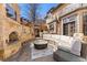 A charming outdoor patio with a stone fireplace, outdoor kitchen, comfortable seating, and lush landscaping surrounding the area at 4160 S Humboldt St, Cherry Hills Village, CO 80113
