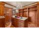 Large wood walk-in closet with ample storage, a marble top island, and stylish chandeliers at 4160 S Humboldt St, Cherry Hills Village, CO 80113