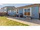 Blue house exterior with grassy backyard, patio, grill, and play area at 5530 Lewiston Ct, Denver, CO 80239