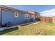 Backyard of the house with a grassy area, patio, and play set at 5530 Lewiston Ct, Denver, CO 80239