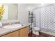 Well-maintained bathroom with a granite countertop vanity and a shower with patterned curtain at 5530 Lewiston Ct, Denver, CO 80239