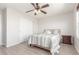Bright bedroom features a ceiling fan, wood floors, and a comfortable bed with stylish bedding at 5530 Lewiston Ct, Denver, CO 80239