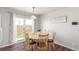 Cozy dining area featuring a round table, wood chairs, and sliding glass doors to the backyard at 5530 Lewiston Ct, Denver, CO 80239