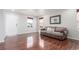 Bright living room with hardwood floors, a comfortable couch, and sunlit windows at 5530 Lewiston Ct, Denver, CO 80239