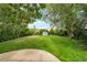 Expansive backyard with lush green grass and mature trees, perfect for outdoor activities at 8280 Auburn Ln, Westminster, CO 80031