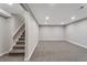 Finished basement with neutral carpet, lighting, and access to the upper floor via stairs at 8280 Auburn Ln, Westminster, CO 80031