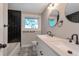 Modern bathroom with double sinks, stylish black and white tile, and sleek fixtures at 8280 Auburn Ln, Westminster, CO 80031