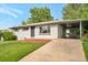 Charming single-story home with a white painted brick exterior, a driveway, and mature trees in the front yard at 8280 Auburn Ln, Westminster, CO 80031