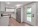 Well-lit kitchen featuring stainless steel appliances, white cabinets and a view to the backyard at 8280 Auburn Ln, Westminster, CO 80031