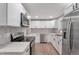 Modern kitchen featuring stainless steel appliances, white cabinets, quartz countertops and a tiled backsplash at 8280 Auburn Ln, Westminster, CO 80031