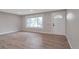 Open living room with hardwood floors, a large window, and a neutral color palette at 8280 Auburn Ln, Westminster, CO 80031