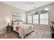 Bright bedroom featuring an area rug and large windows that let in natural light at 2870 W Riverwalk Cir # B, Littleton, CO 80123