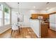 Bright dining area adjacent to the kitchen, featuring hardwood floors and modern lighting at 2870 W Riverwalk Cir # B, Littleton, CO 80123