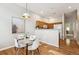 Open dining area with a table set for four, and views of the kitchen at 2870 W Riverwalk Cir # B, Littleton, CO 80123
