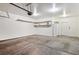 Spacious garage featuring clean concrete flooring, shelving, and a garage door opener at 2870 W Riverwalk Cir # B, Littleton, CO 80123