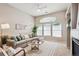 Inviting living room featuring a comfortable sofa, ceiling fan, and plenty of natural light at 2870 W Riverwalk Cir # B, Littleton, CO 80123